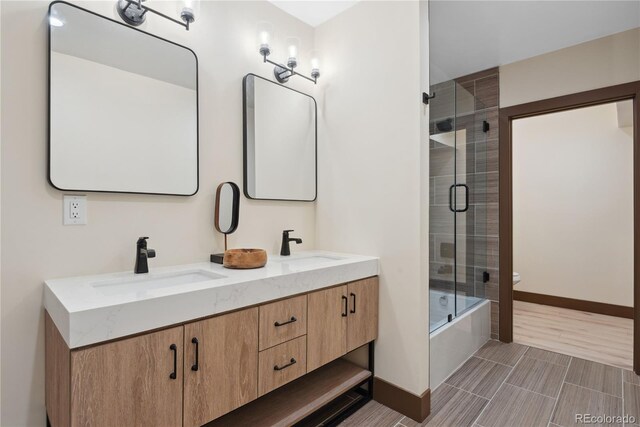1298 Meadow View Dr, Evergreen, CO 80439 - bathroom with double vanity and bath / shower combo with glass door
