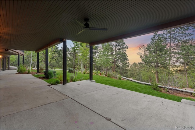 1298 Meadow View Dr, Evergreen, CO 80439 - patio terrace at dusk featuring a ceiling fan, a patio area, and a yard