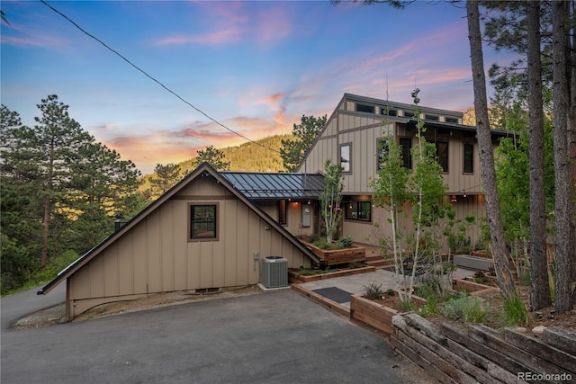 1298 Meadow View Dr, Evergreen, CO 80439 - view of front of home with a standing seam roof, a metal roof, board and batten siding, and a patio