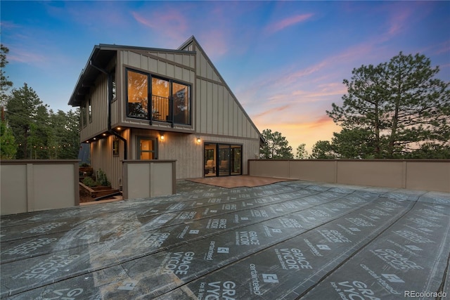 1298 Meadow View Dr, Evergreen, CO 80439 - back of house at dusk featuring board and batten siding