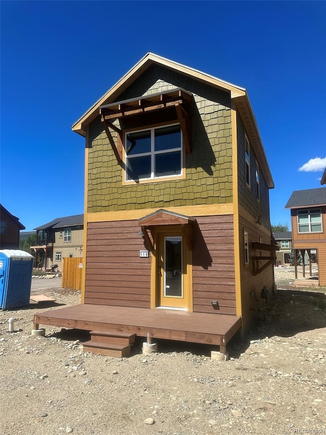 rear view of property featuring a deck