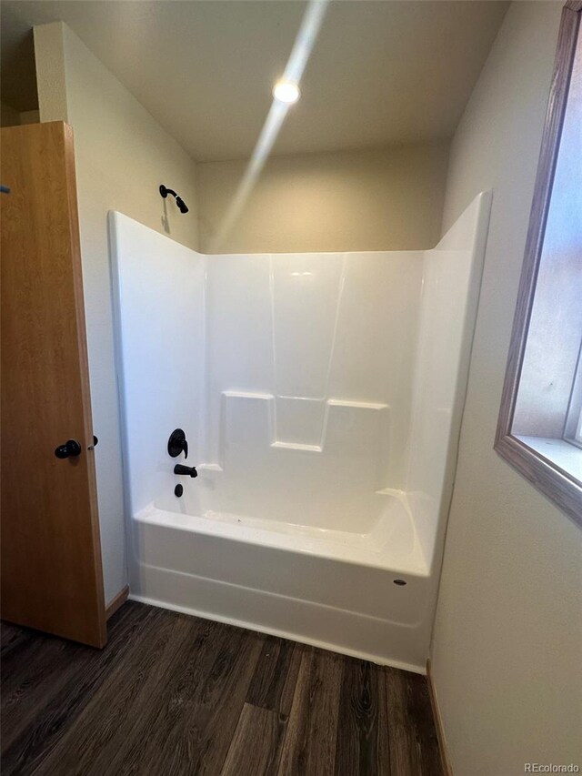 bathroom featuring tub / shower combination and hardwood / wood-style floors