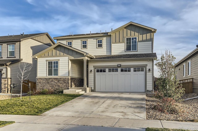 6645 Dry Fork Dr, Frederick, CO 80516 - view of front of home with board and batten siding, a garage, driveway, and stone siding