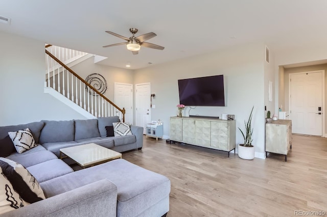6645 Dry Fork Dr, Frederick, CO 80516 - living room featuring ceiling fan, stairway, light wood-style floors, and baseboards