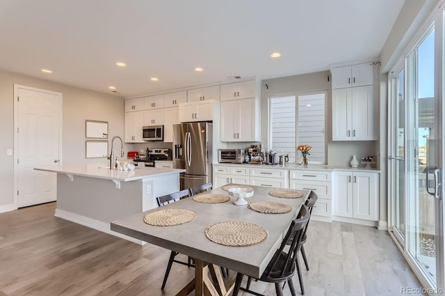 6645 Dry Fork Dr, Frederick, CO 80516 - dining room featuring light wood-style flooring, recessed lighting, and baseboards