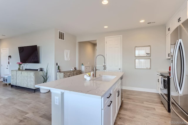 6645 Dry Fork Dr, Frederick, CO 80516 - kitchen featuring a sink, stainless steel appliances, light wood-style flooring, white cabinets, and recessed lighting