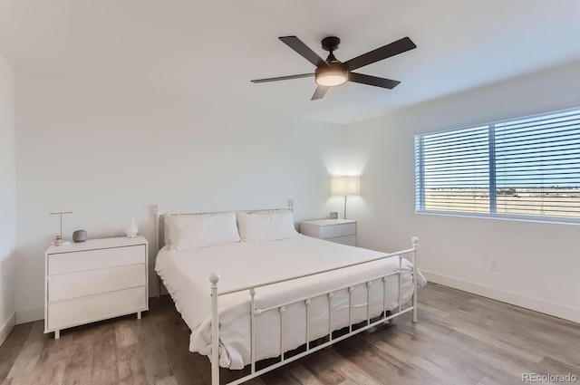 6645 Dry Fork Dr, Frederick, CO 80516 - bedroom featuring baseboards, wood finished floors, and ceiling fan