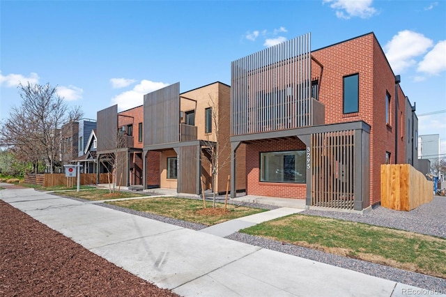 view of building exterior with fence and a residential view