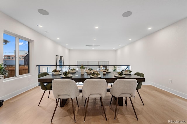 dining space featuring light wood-style floors, baseboards, and recessed lighting