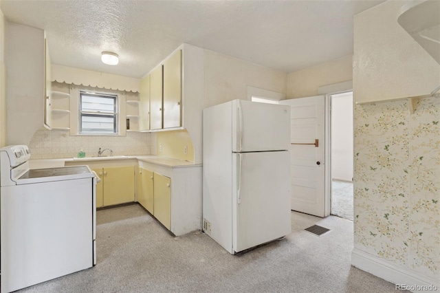 kitchen with visible vents, freestanding refrigerator, open shelves, light countertops, and electric range oven