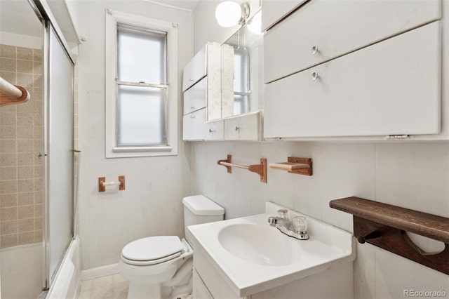 full bath featuring vanity, enclosed tub / shower combo, and toilet