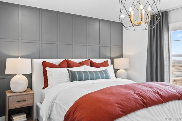 17137 W 91st Ln, Arvada, CO 80007 - bedroom featuring a decorative wall and a chandelier