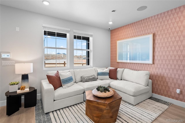 17137 W 91st Ln, Arvada, CO 80007 - living area featuring an accent wall, wallpapered walls, light wood-type flooring, baseboards, and recessed lighting