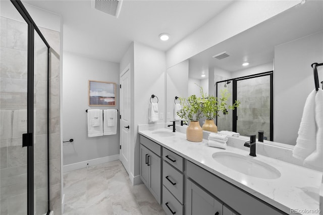 17137 W 91st Ln, Arvada, CO 80007 - bathroom with marble look tile flooring, a shower stall, double vanity, baseboards, and recessed lighting