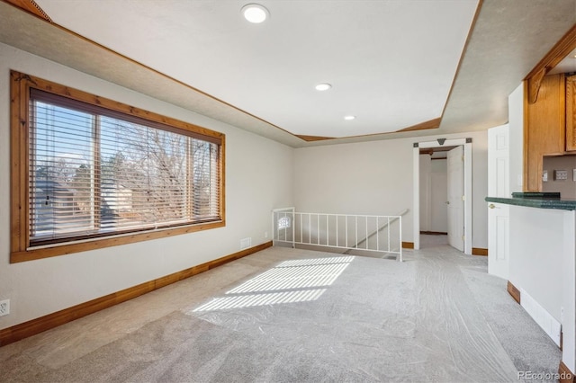 empty room with light carpet, baseboards, and recessed lighting