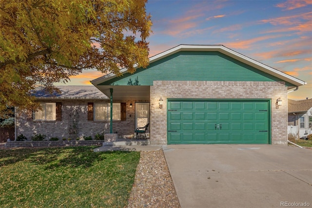 view of front of property featuring a garage and a yard