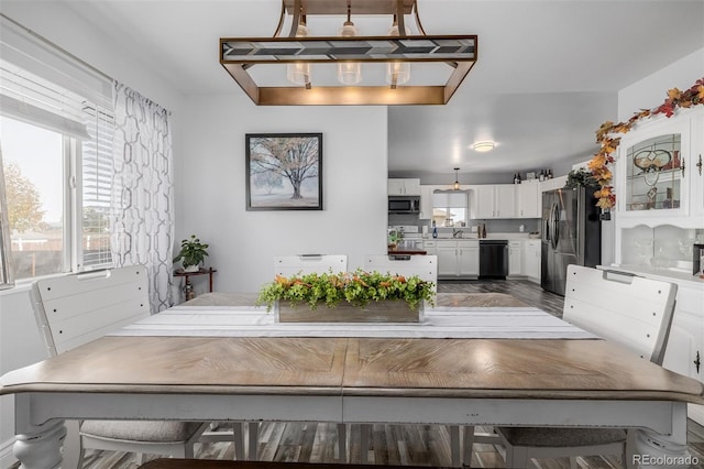 unfurnished dining area featuring dark hardwood / wood-style flooring