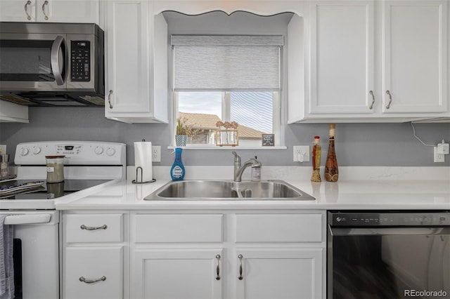 kitchen featuring white range with electric stovetop, sink, dishwashing machine, and white cabinets