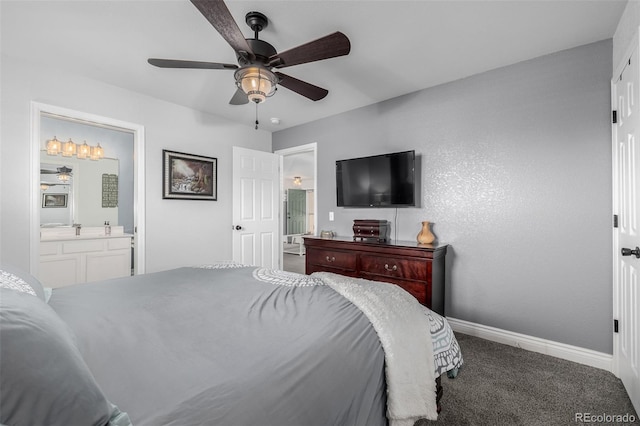 carpeted bedroom with ceiling fan and ensuite bathroom