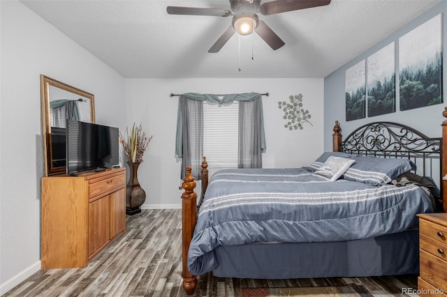 bedroom featuring ceiling fan, a textured ceiling, and hardwood / wood-style flooring