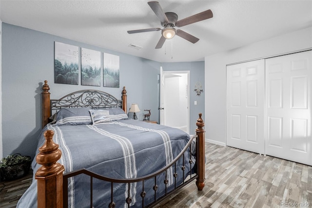 bedroom with ceiling fan, hardwood / wood-style floors, and a closet