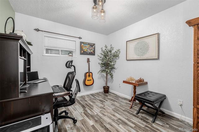 office area featuring hardwood / wood-style flooring and a textured ceiling