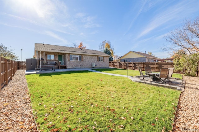 rear view of house with a lawn and a patio area