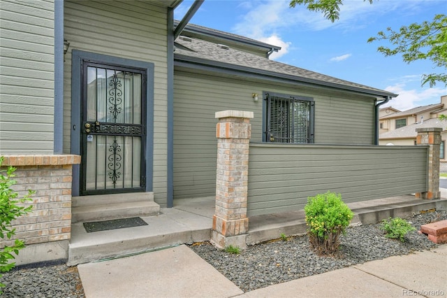 9183 W Cedar Dr Unit 2, Lakewood, CO 80226 - view of exterior entry with roof with shingles