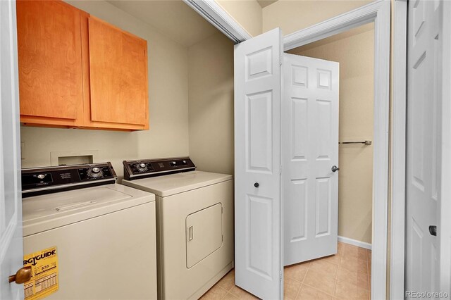 9183 W Cedar Dr Unit 2, Lakewood, CO 80226 - washroom with cabinet space, washer and clothes dryer, light tile patterned floors, and baseboards