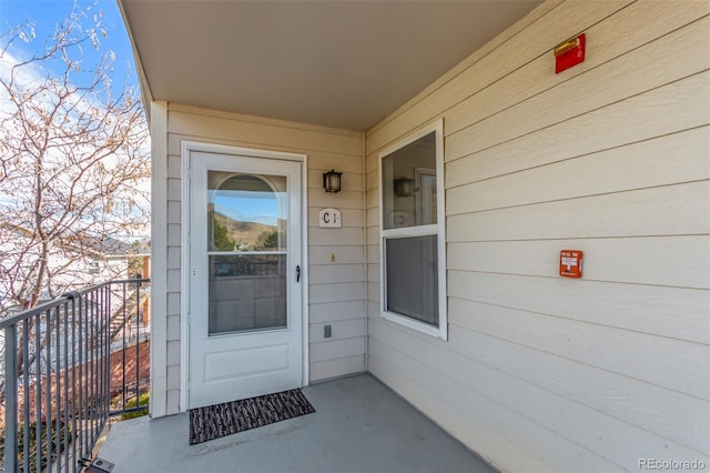 view of exterior entry featuring a balcony