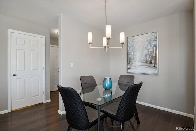 dining space featuring baseboards and wood finished floors