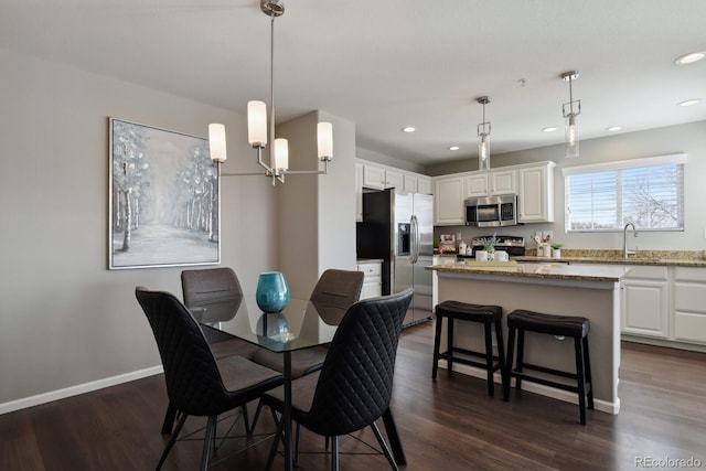 dining area with recessed lighting, dark wood finished floors, and baseboards