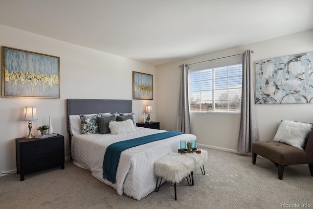 bedroom featuring light carpet and baseboards