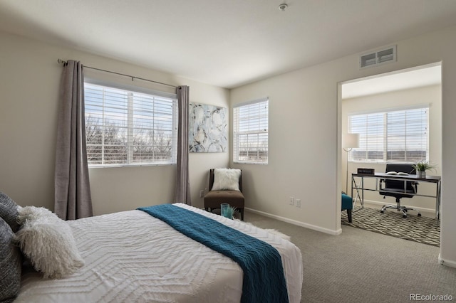 carpeted bedroom with visible vents and baseboards