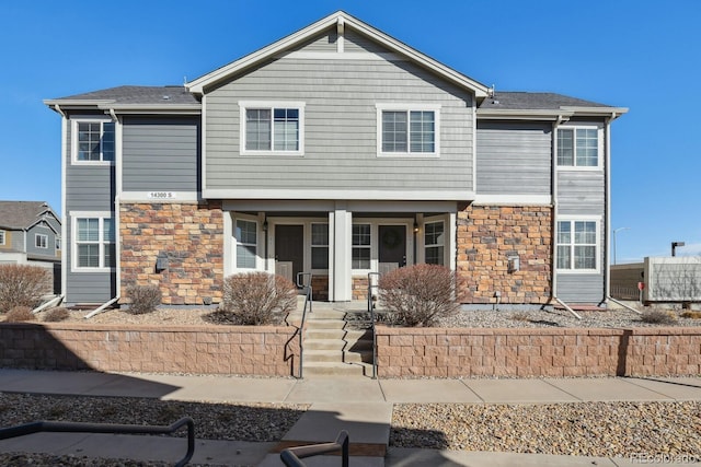 view of front facade featuring stone siding and a porch