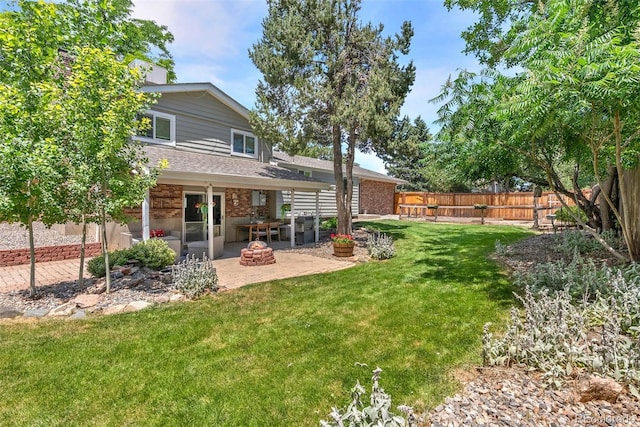 7306 S Dexter St, Centennial, CO 80122 - back of property featuring a patio area, a fenced backyard, brick siding, and roof with shingles