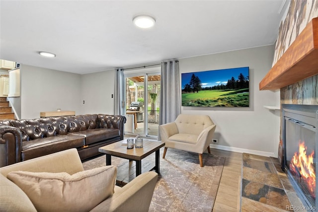 7306 S Dexter St, Centennial, CO 80122 - living room with a fireplace with flush hearth, stairway, and wood finished floors