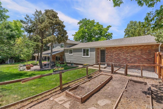 7306 S Dexter St, Centennial, CO 80122 - back of property featuring a garden, a patio, a yard, brick siding, and a shingled roof