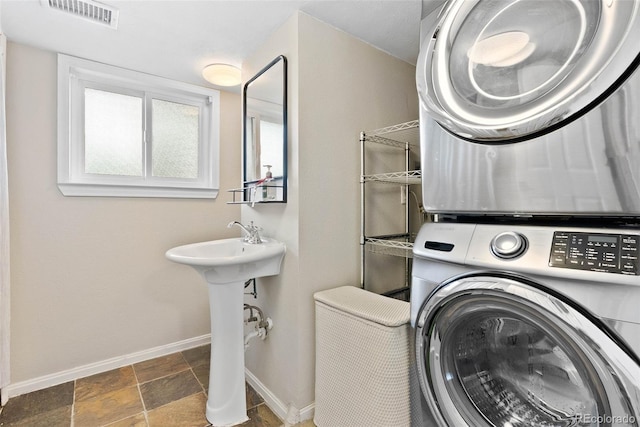 7306 S Dexter St, Centennial, CO 80122 - washroom with estacked washer and dryer and stone finish flooring