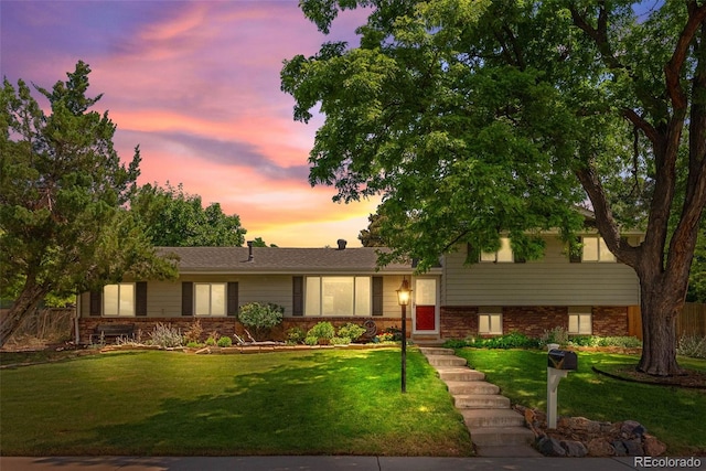 7306 S Dexter St, Centennial, CO 80122 - tri-level home featuring a front yard and brick siding