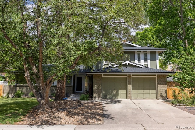 7150 S Curtice St, Littleton, CO 80120 - view of front of property featuring driveway, brick siding, and an attached garage