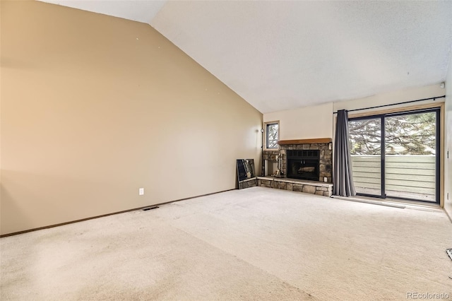 unfurnished living room with carpet, plenty of natural light, a fireplace, baseboards, and high vaulted ceiling