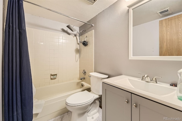 bathroom featuring toilet, shower / bath combo with shower curtain, and vanity
