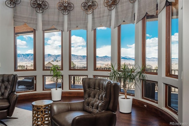 sunroom with plenty of natural light and a mountain view