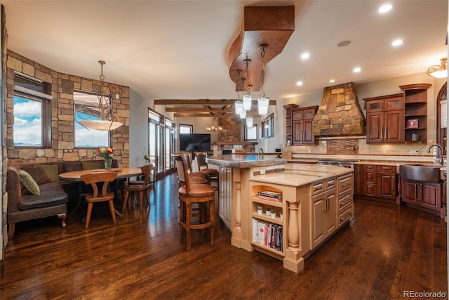 kitchen with custom exhaust hood, open shelves, decorative backsplash, open floor plan, and a sink