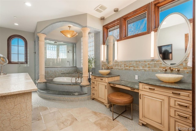 full bath with decorative columns, visible vents, vanity, a bath, and walk in shower