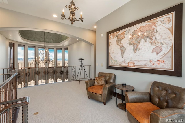 living area with an inviting chandelier, carpet, arched walkways, and recessed lighting