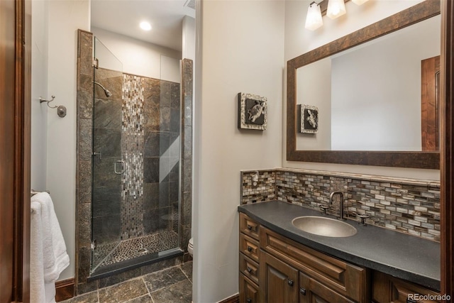 full bathroom with toilet, a stall shower, tasteful backsplash, and vanity