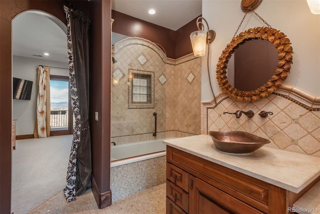 full bathroom with recessed lighting, tasteful backsplash, tile walls, and vanity