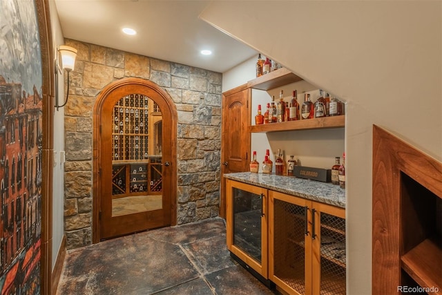 wine area featuring recessed lighting, beverage cooler, and a dry bar